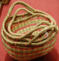 Lot 1252 - A graduated set of three multicoloured wicker...