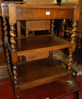 Lot 1270 - A 1930s barleytwist oak three-tier tea trolley,...