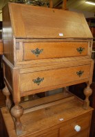 Lot 1272 - An early 20th century moulded oak slopefront...