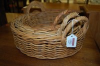 Lot 1312 - A graduated set of three wicker twin handled...