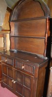 Lot 1323 - An oak dome-top dresser