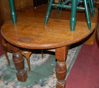 Lot 1349 - An early 20th century oak extending dining...