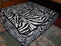 Lot 1351 - A contemporary zebra print upholstered foot stool