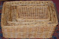Lot 1364 - A graduated set of three wicker carrying...