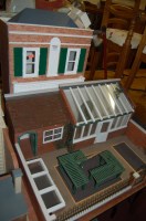 Lot 1374 - A small painted two storey dolls house,...