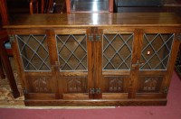 Lot 1396 - A moulded oak and lead glazed four door...