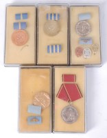 Lot 483 - A collection of five boxed East German medals...