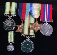 Lot 682 - A group of four medals to include WW II...