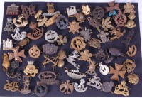 Lot 603 - A collection of assorted military cap badges...