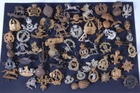 Lot 604 - A collection of assorted military cap badges...