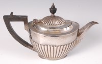 Lot 422 - A Geo. V. silver tea pot of oval half...