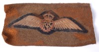 Lot 436 - A post WW I RFC cloth wing badge on a felt...