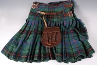 Lot 552 - A post WW II tartan kilt with leather straps...