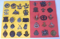 Lot 563 - A collection of assorted cap badges and...