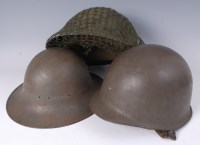 Lot 595 - A post WW II Brodie pattern steel helmet,...