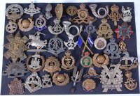 Lot 607 - A collection of assorted military cap badges...