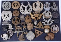 Lot 611 - A collection of assorted military cap badges...