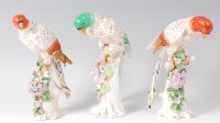 Lot 1058 - A set of three circa 1900 porcelain parrots,...