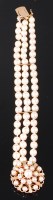 Lot 1169 - A 9ct gold cultured pearl triple string...