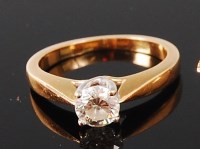 Lot 1174 - An 18ct gold diamond solitaire ring, the four...