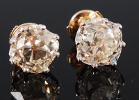 Lot 1185 - A pair of 18ct gold diamond ear studs, the...