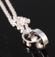 Lot 1208 - A boxed Cartier 18ct white gold pendant and...