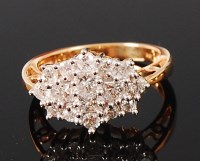 Lot 1211 - An 18ct gold diamond cluster ring, arranged as...