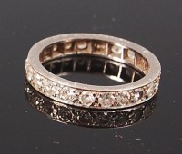 Lot 1221 - An 18ct white gold and diamond eternity ring,...