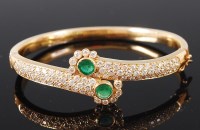 Lot 1222 - A modern ladies yellow metal, emerald and...