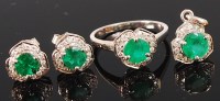 Lot 1237 - A silver, emerald and diamond set three piece...