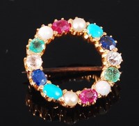 Lot 1254 - A gold multi-stone brooch, of circular form,...