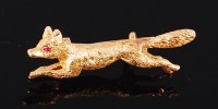 Lot 1255 - A gold brooch, modelled as a fox, having ruby...