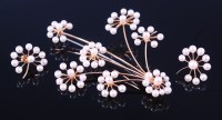 Lot 1155 - A contemporary 22ct gold seed pearl set flower...