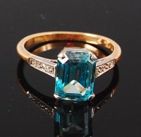 Lot 1289 - An 18ct gold and blue topaz set dress ring,...