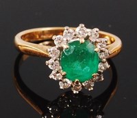 Lot 1177 - An 18ct gold, emerald and diamond cluster ring,...