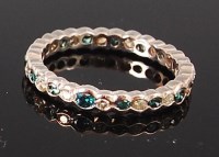 Lot 1261 - A silver and diamond set eternity ring,...