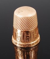 Lot 1375 - A Victorian yellow metal thimble, unmarked but...