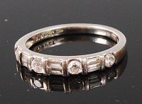 Lot 1257 - A platinum and diamond set half eternity ring,...