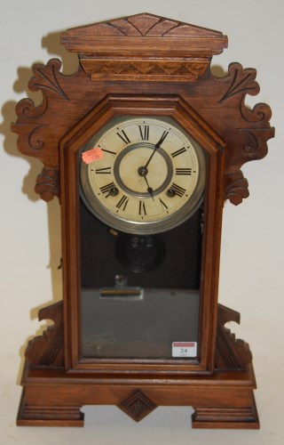 Lot 24 - A late 19th century walnut cased mantel clock,...