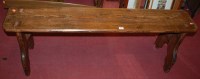 Lot 1258 - A stained pine bench, of joined construction,...