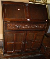 Lot 1269 - A moulded oak bureau bookcase, having twin...