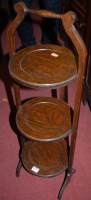 Lot 1279 - A 1930s oak circular three tier folding cake...