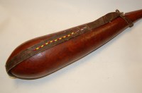 Lot 156 - A mid 20th century leather clad tribal water...