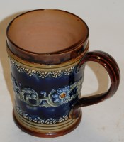Lot 244 - A Victorian Doulton Lambeth mug, on a mottled...