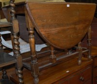 Lot 1213 - An early 20th century moulded oak drop leaf...
