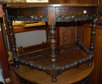 Lot 1225 - A pair of Continental oak demi-lune side...