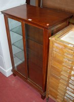 Lot 1233 - An Edwardian walnut double door glazed display...