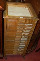 Lot 1234 - An early 20th century light oak 14-drawer...