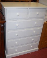 Lot 1243 - A contemporary white wood chest of two short...