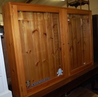 Lot 1246 - A modern pine double door glazed hanging...